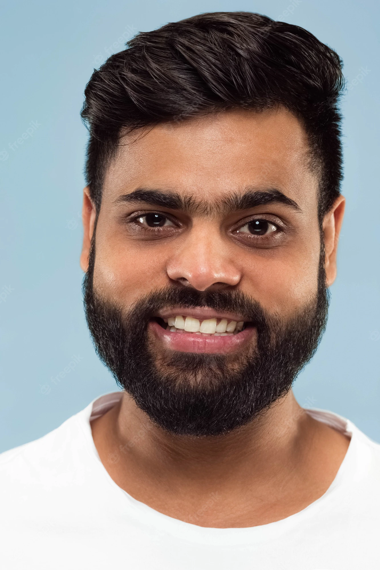 close-up-portrait-young-indian-man-with-beard-white-shirt-isolated-standing-smiling_155003-23823